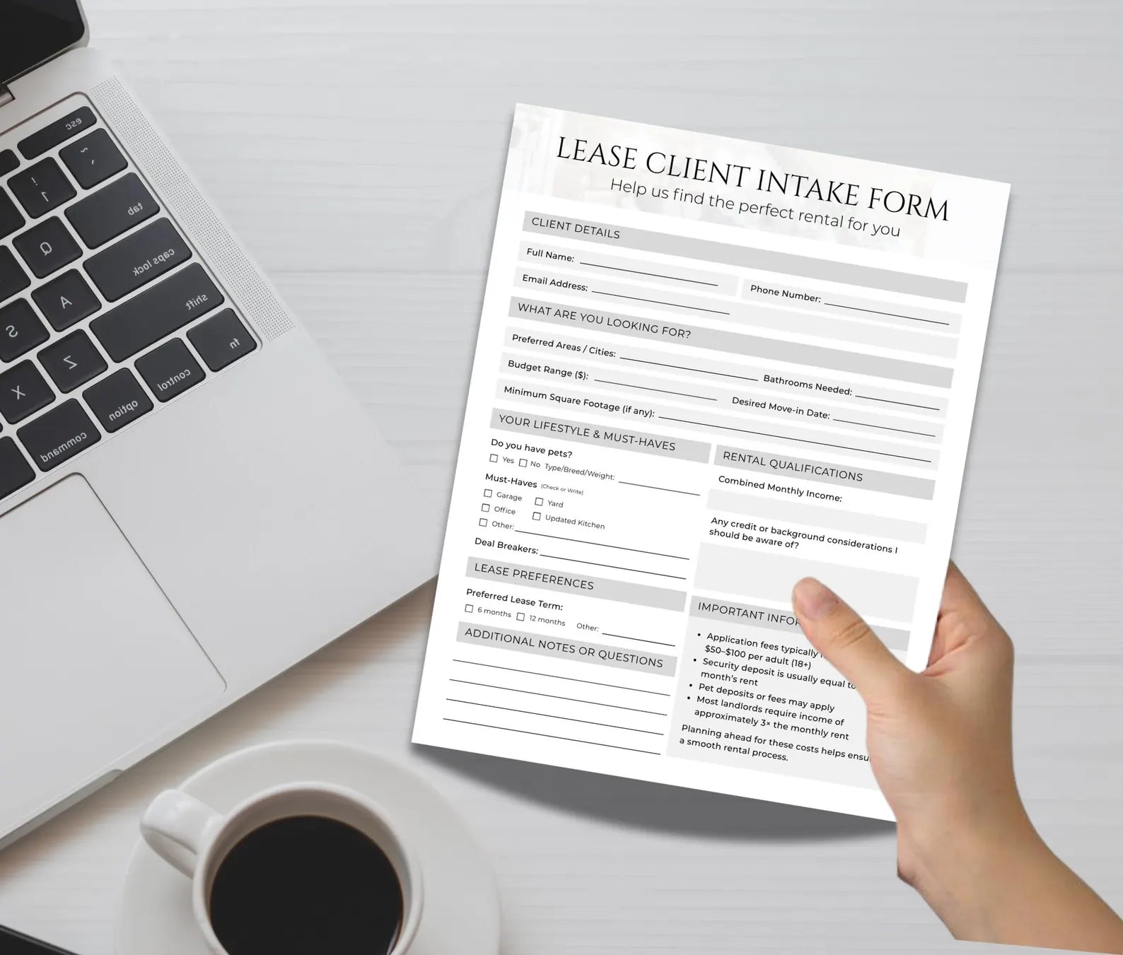 A hand holding a printed 'Lease Client Intake Form' over a desk with a laptop, coffee cup, and notepad.